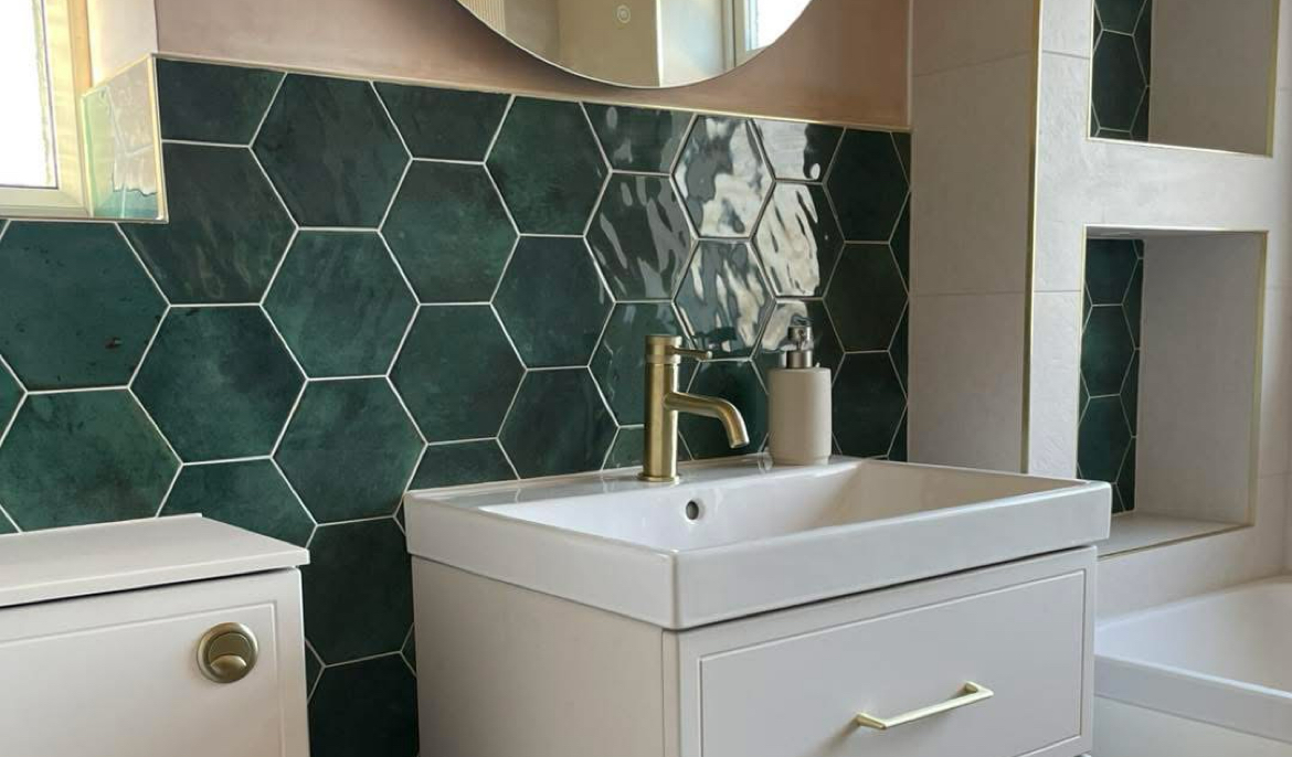 Recently completed en-suite with green hexagon tiling and brass fittings, an MM Plumbing Services install